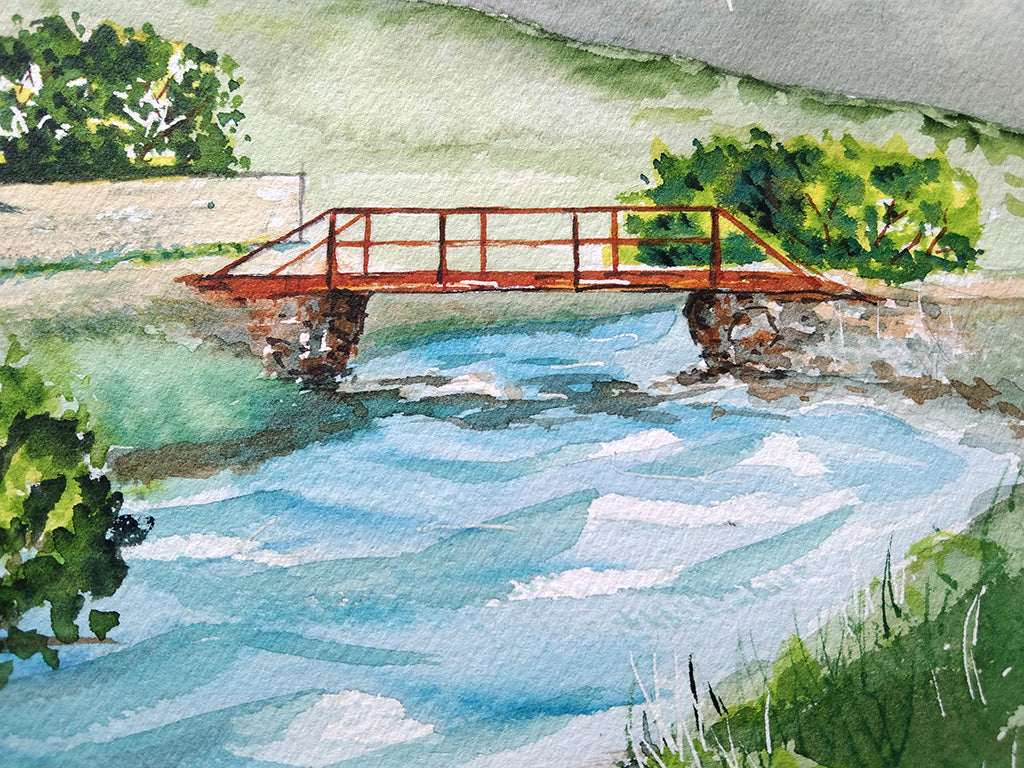 Detalle del puente anaranjado que cruza el río en la acuarela del Santuario de Montgarri, símbolo de conexión y camino.