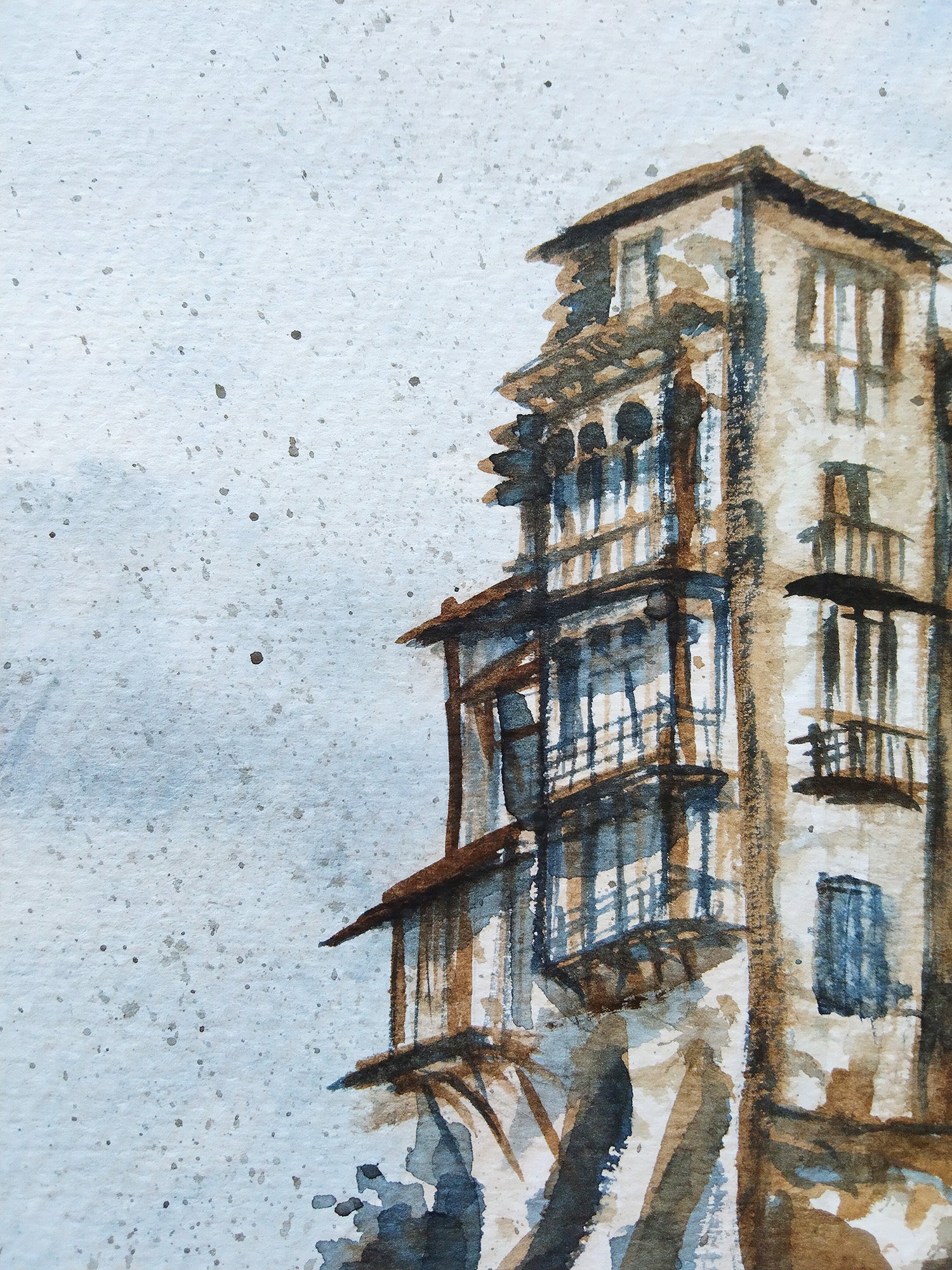 Detalle de las casas colgantes de Cuenca pintadas en acuarela, capturando su arquitectura de balconadas sobre el precipicio, con tonos sombra tostada y gris azulado.